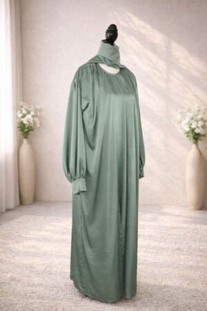 Raha Abaya in Soft Sage Green, minimal everyday abaya with loose flowing fit and subtle satin sheen